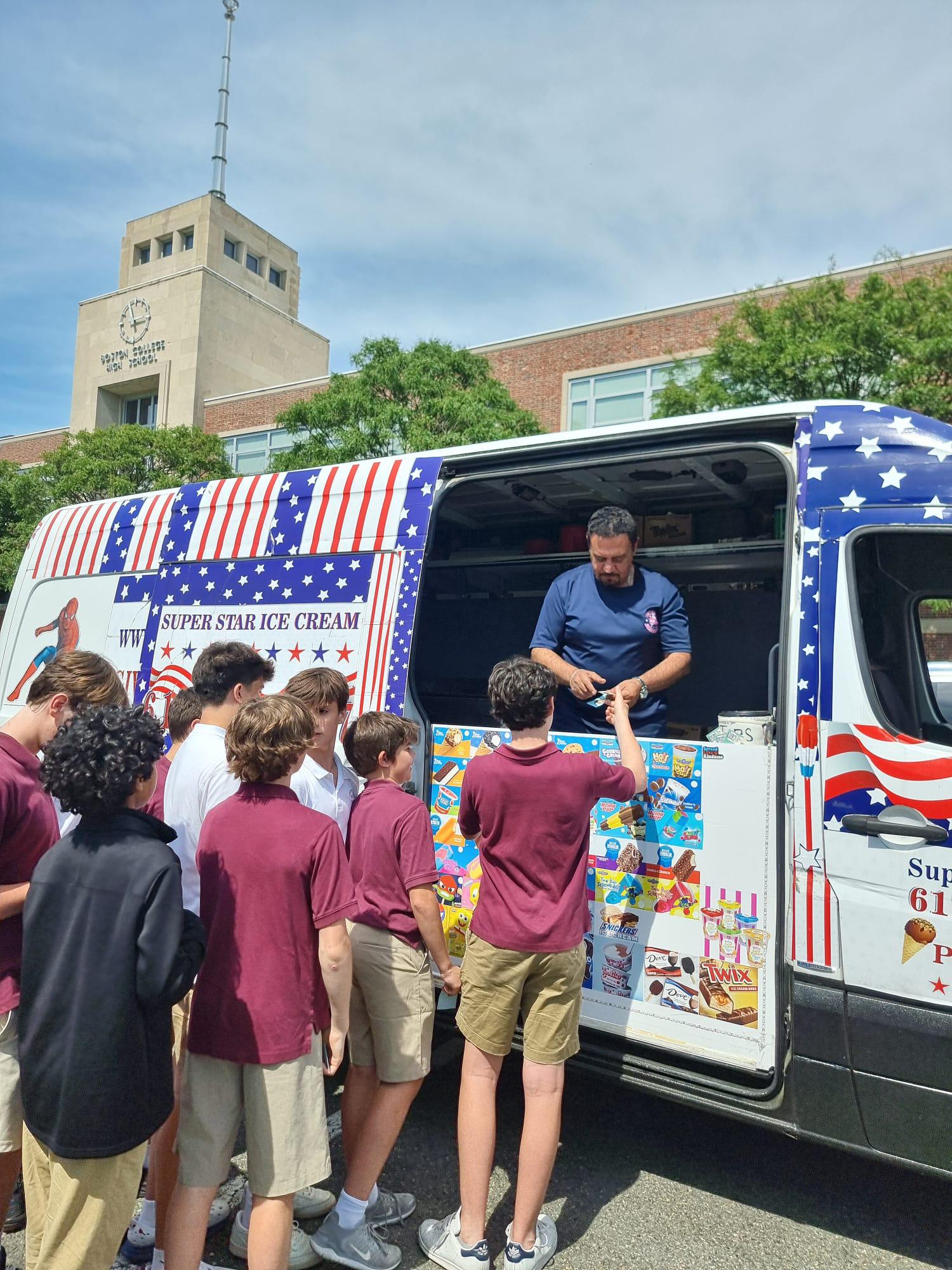 Ice cream truck serving graduates during outdoor celebration