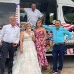Ice cream truck at an outdoor wedding celebration serving guests