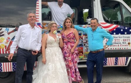 Ice cream truck at an outdoor wedding celebration serving guests