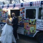 Elegant ice cream truck at outdoor wedding serving guests frozen treats
