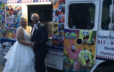 Elegant ice cream truck at outdoor wedding serving guests frozen treats