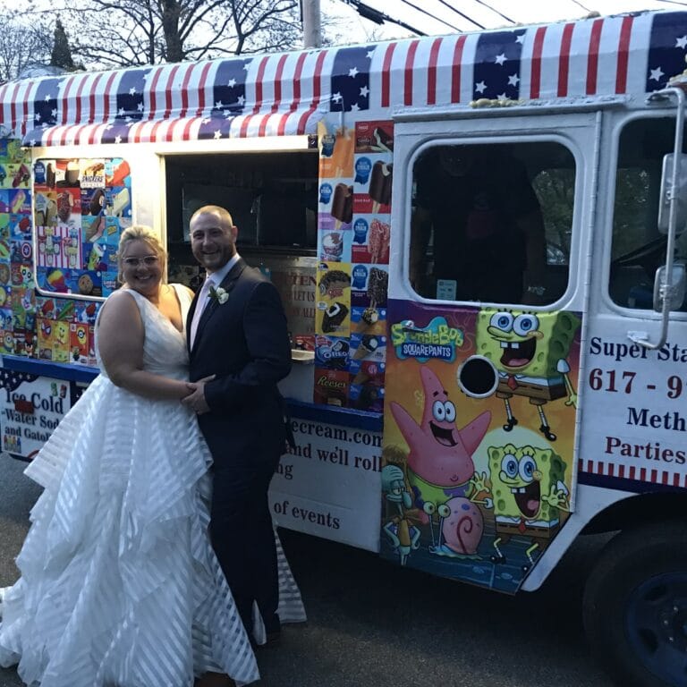 Elegant ice cream truck at outdoor wedding serving guests frozen treats
