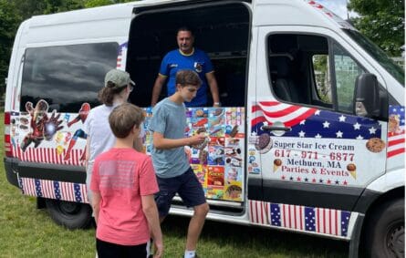 Ice cream truck serving kids at a youth sports event