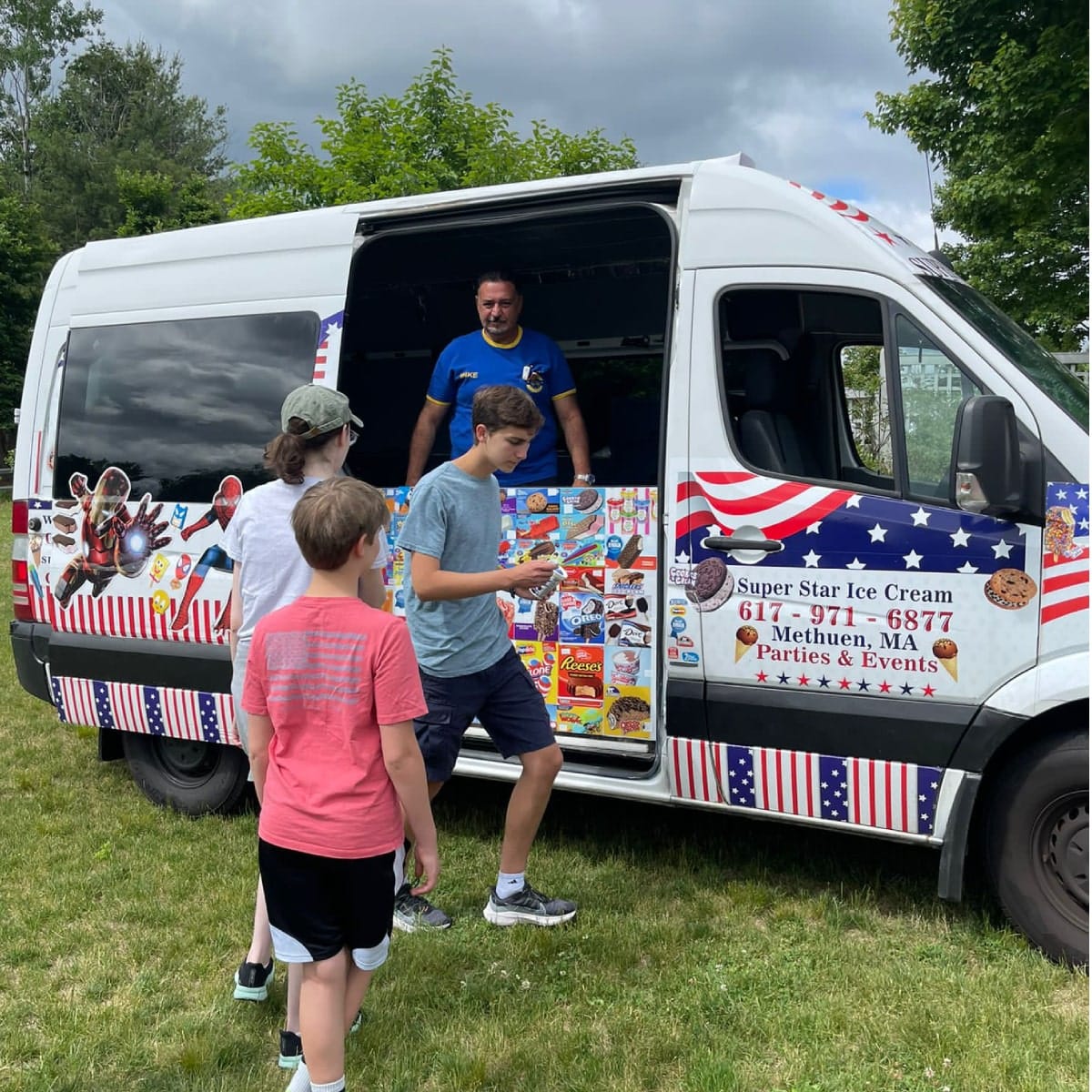 Ice cream truck serving kids at a youth sports event