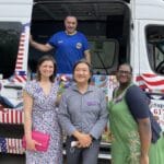 Ice cream truck catering event in Concord MA with happy families enjoying treats