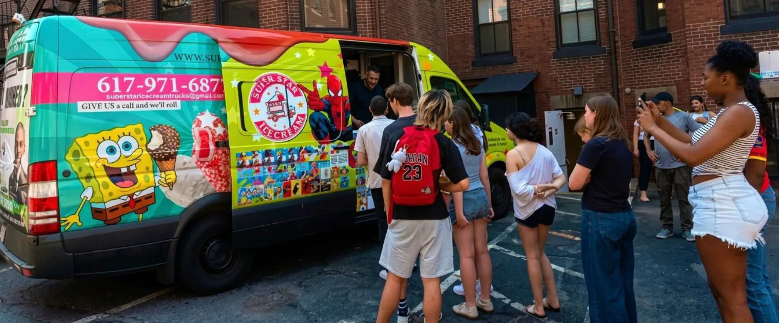 Guests choosing frozen treats from the Super Star Ice Cream catering truck