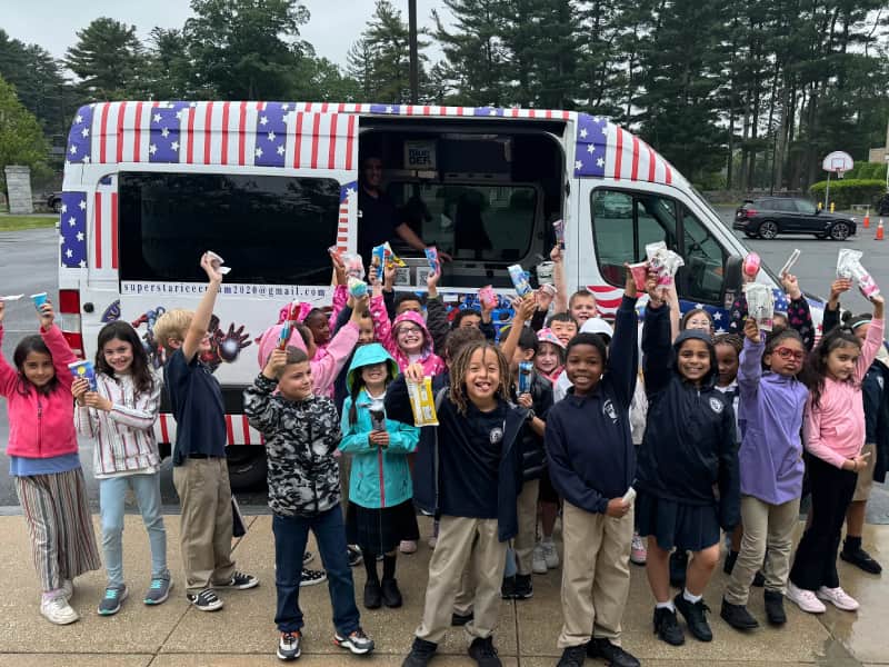 Customers enjoying Super Star Ice Cream Truck service at an event in Massachusetts