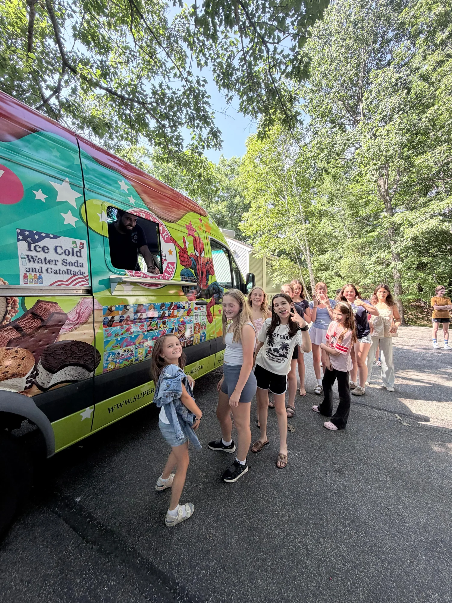 Super Star Ice Cream truck serving a birthday party in Avon, MA with families and children enjoying frozen treats